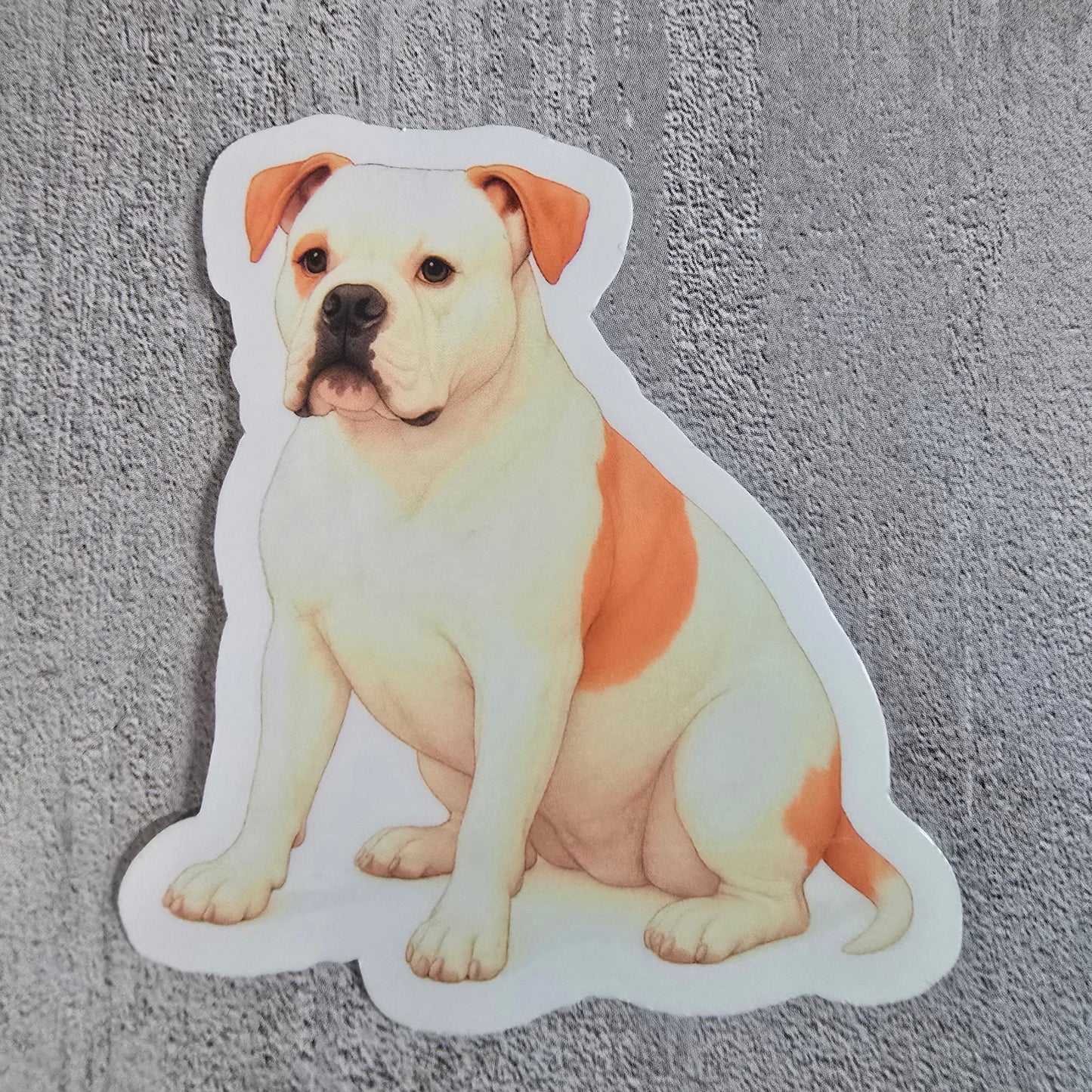 Sticker of a dog lying on its side on a textured gray surface