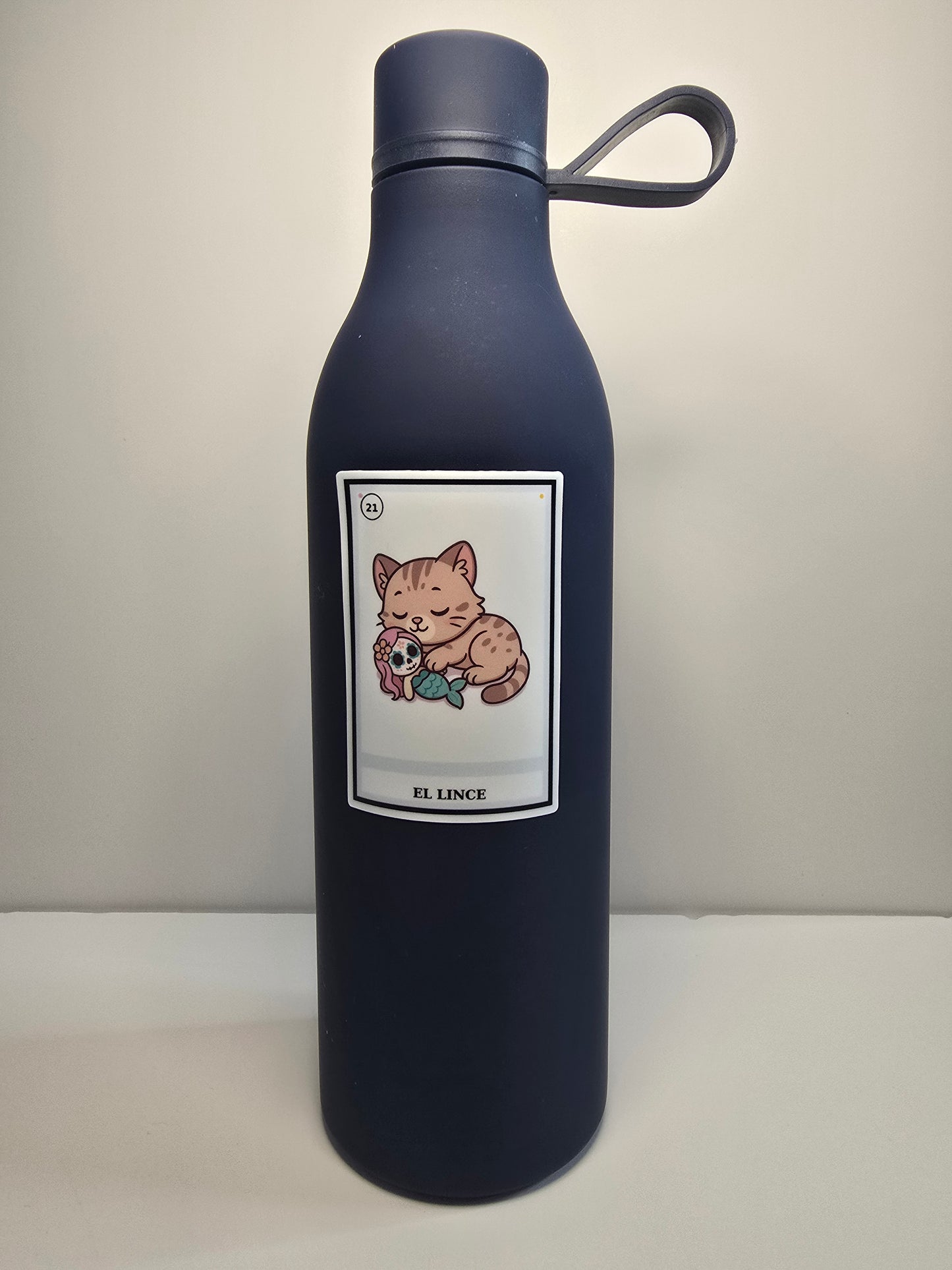 Black water bottle with a label featuring cartoon characters on a light gray background