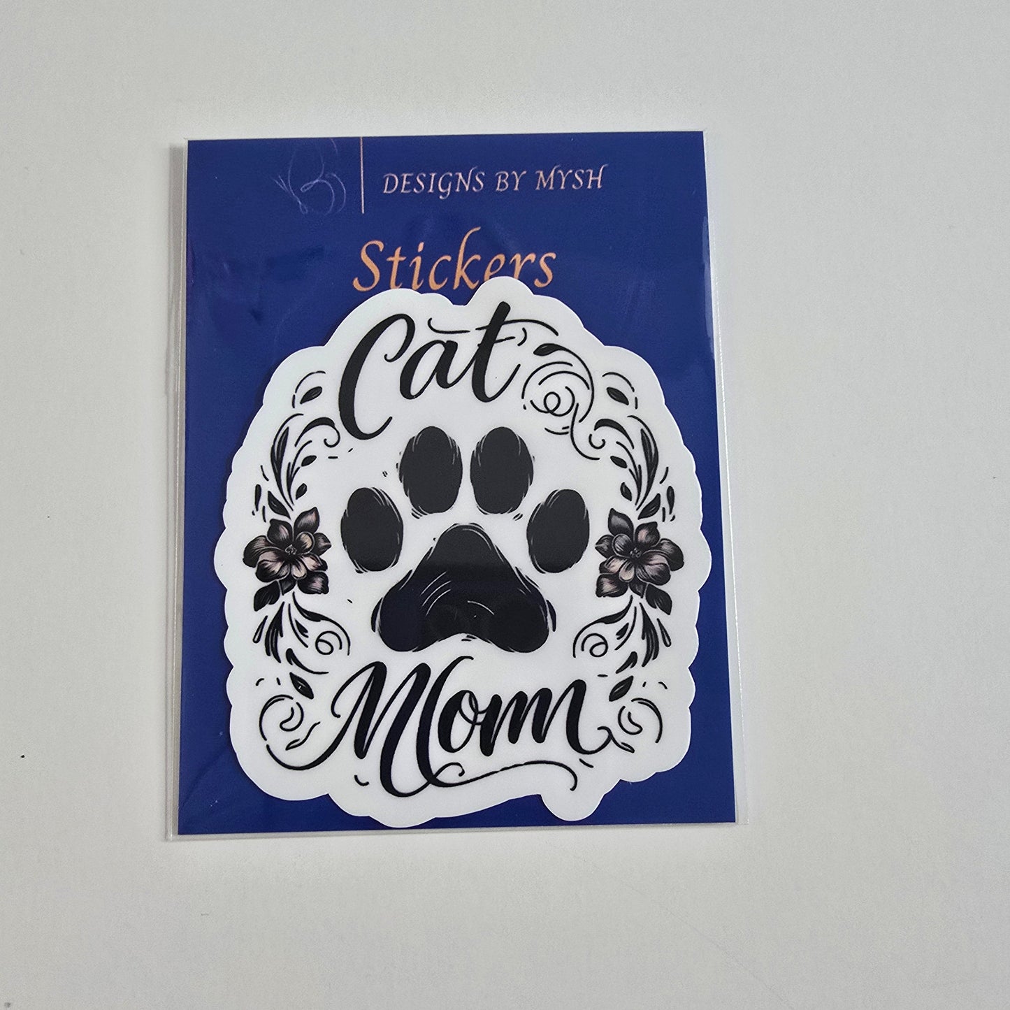 Vinyl sticker with black paw print and floral design that reads "Cat Mom" in script.