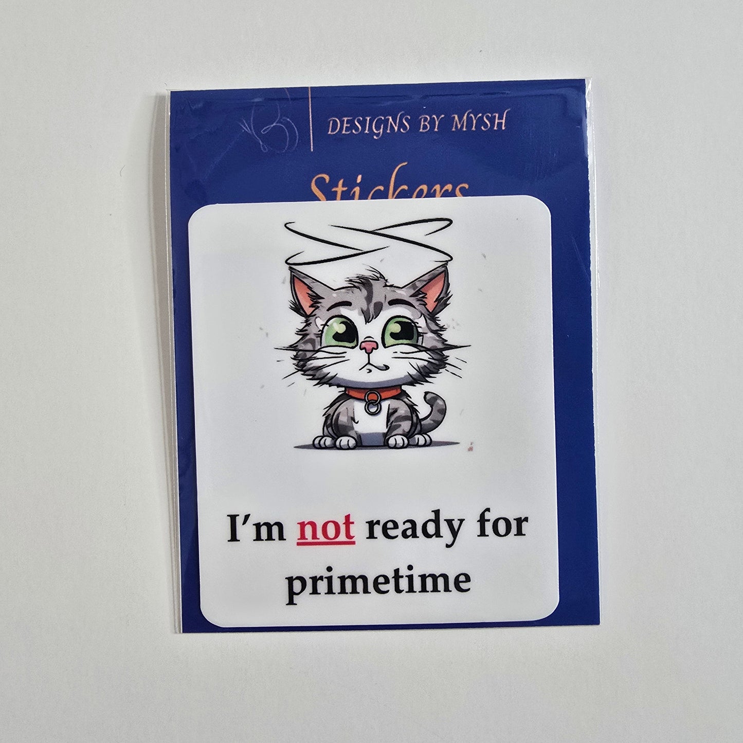 Cartoon sticker of a halo-wearing gray tabby cat with the caption "I'm not ready for primetime."