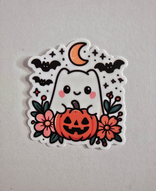 Cute vinyl die-cut Halloween sticker featuring a smiling ghost inside a jack-o’-lantern, surrounded by flowers, bats, stars, and a crescent moon.