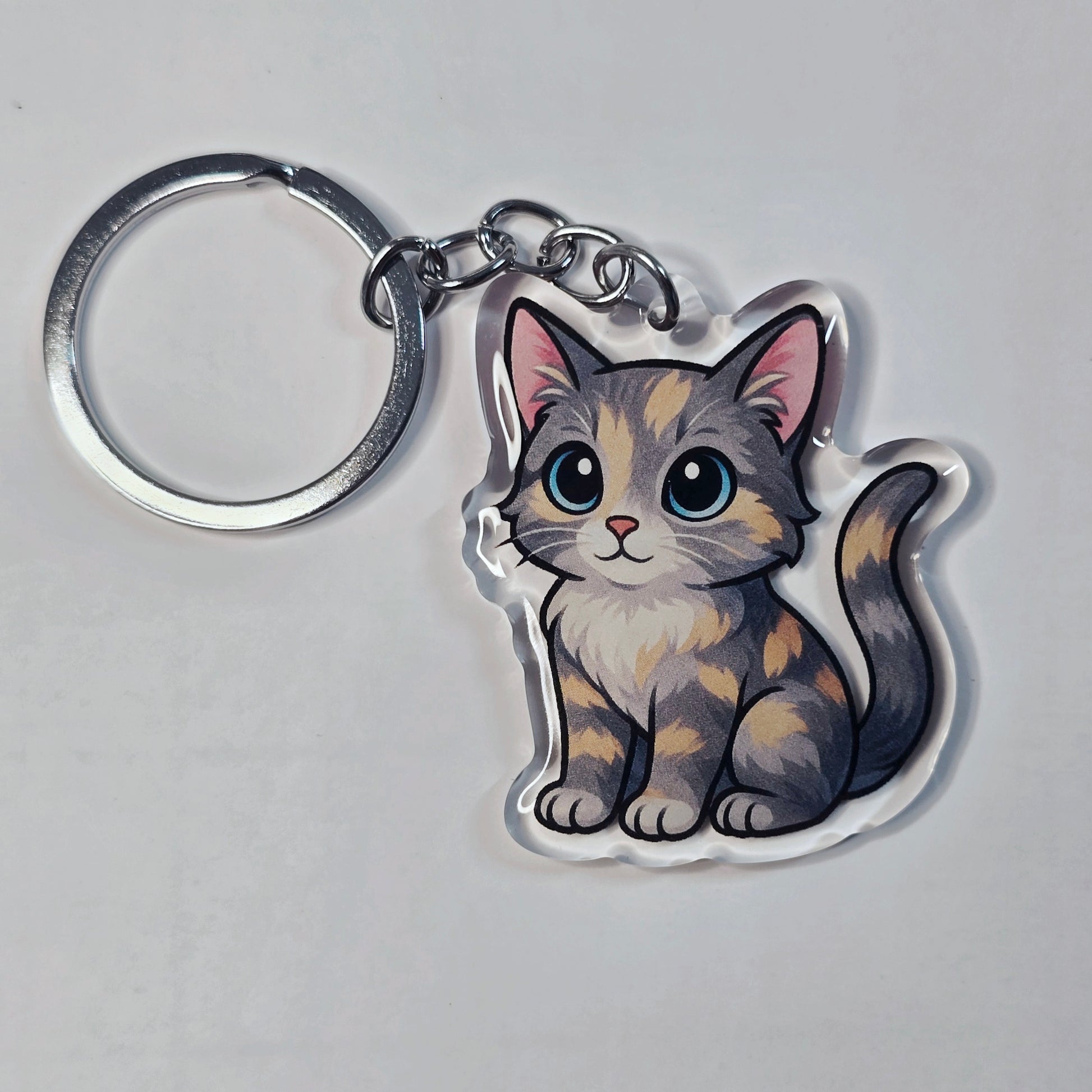 Keychain with a cute cat design on a gray background