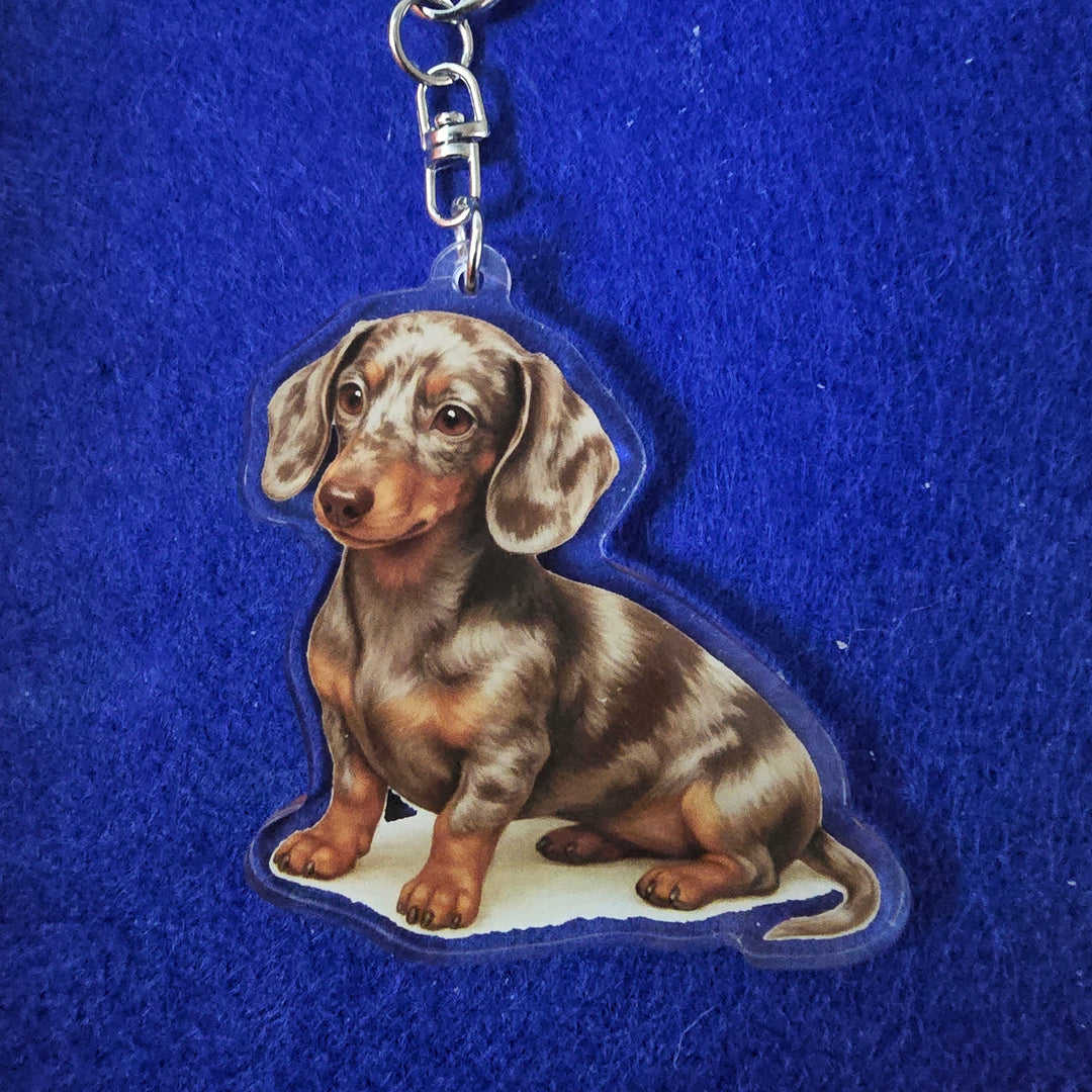 Keychain with a dachshund design on a blue background