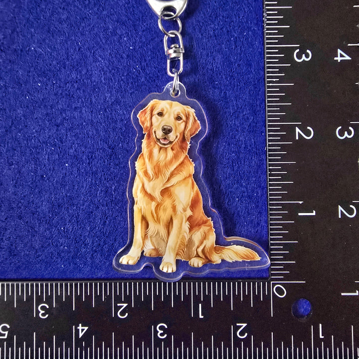 Dog-shaped keychain on a blue background with a ruler for scale.
