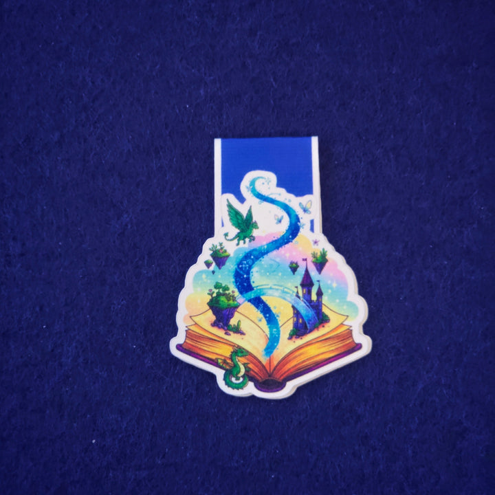 Colorful sticker of a dragon on an open book against a dark blue background