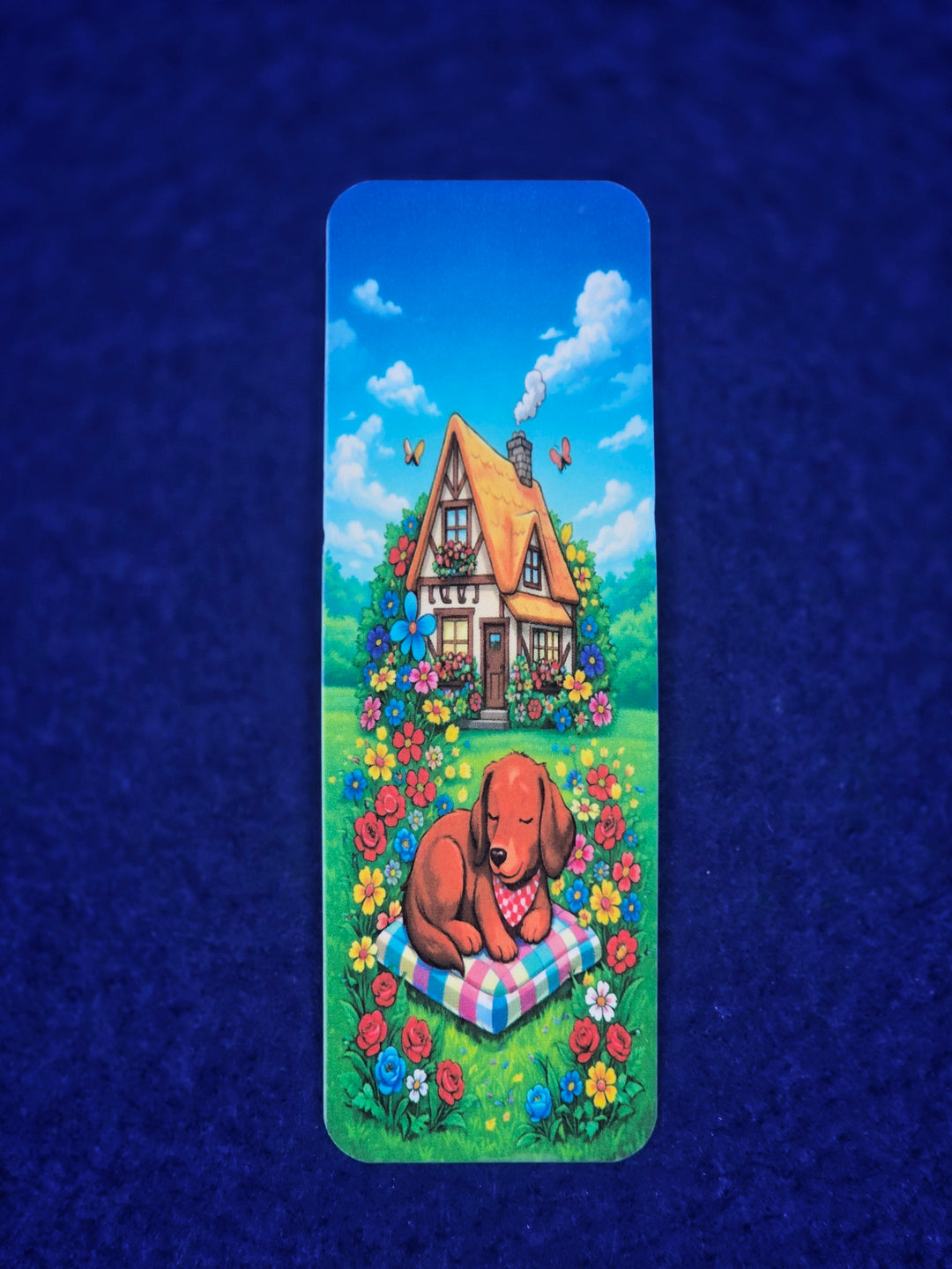 Bookmark with a dog and house illustration on a blue textured background
