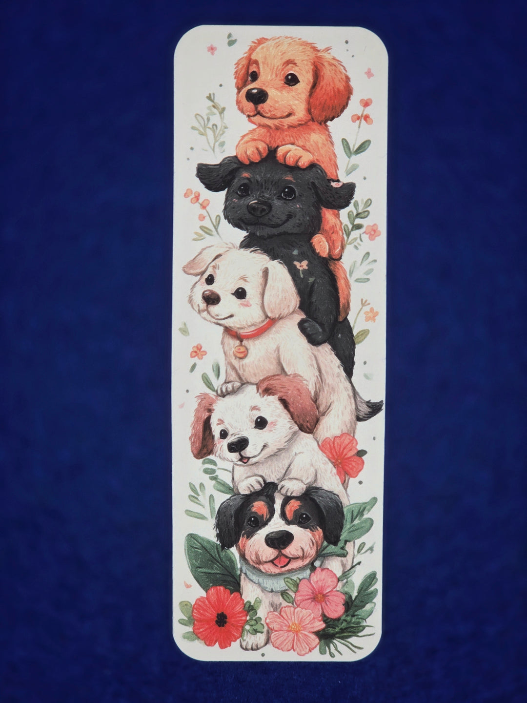 Bookmark with illustrations of puppies and flowers on a blue background