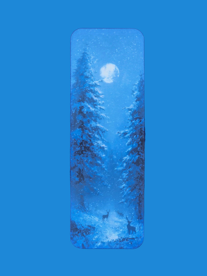 Framed artwork of a forest scene with deer under a full moon on a blue textured background