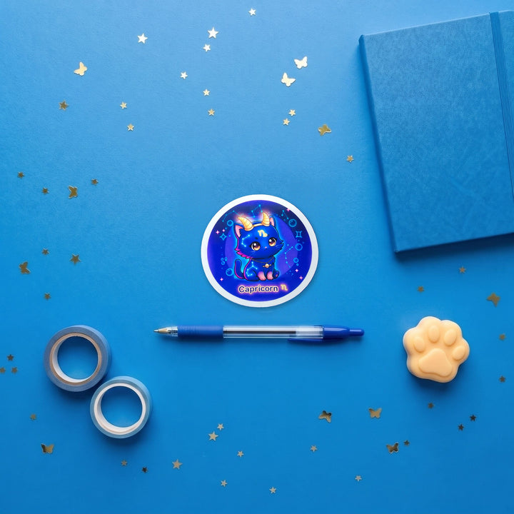 Zodiac Capricorn Cat 3 inch fridge magnet flat lay with blue stationery