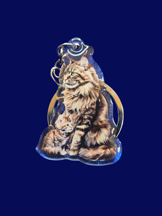 A collection of acrylic cat keychains in various colors, each featuring an image of a cat with a glossy finish, displayed on a blue textured surface.