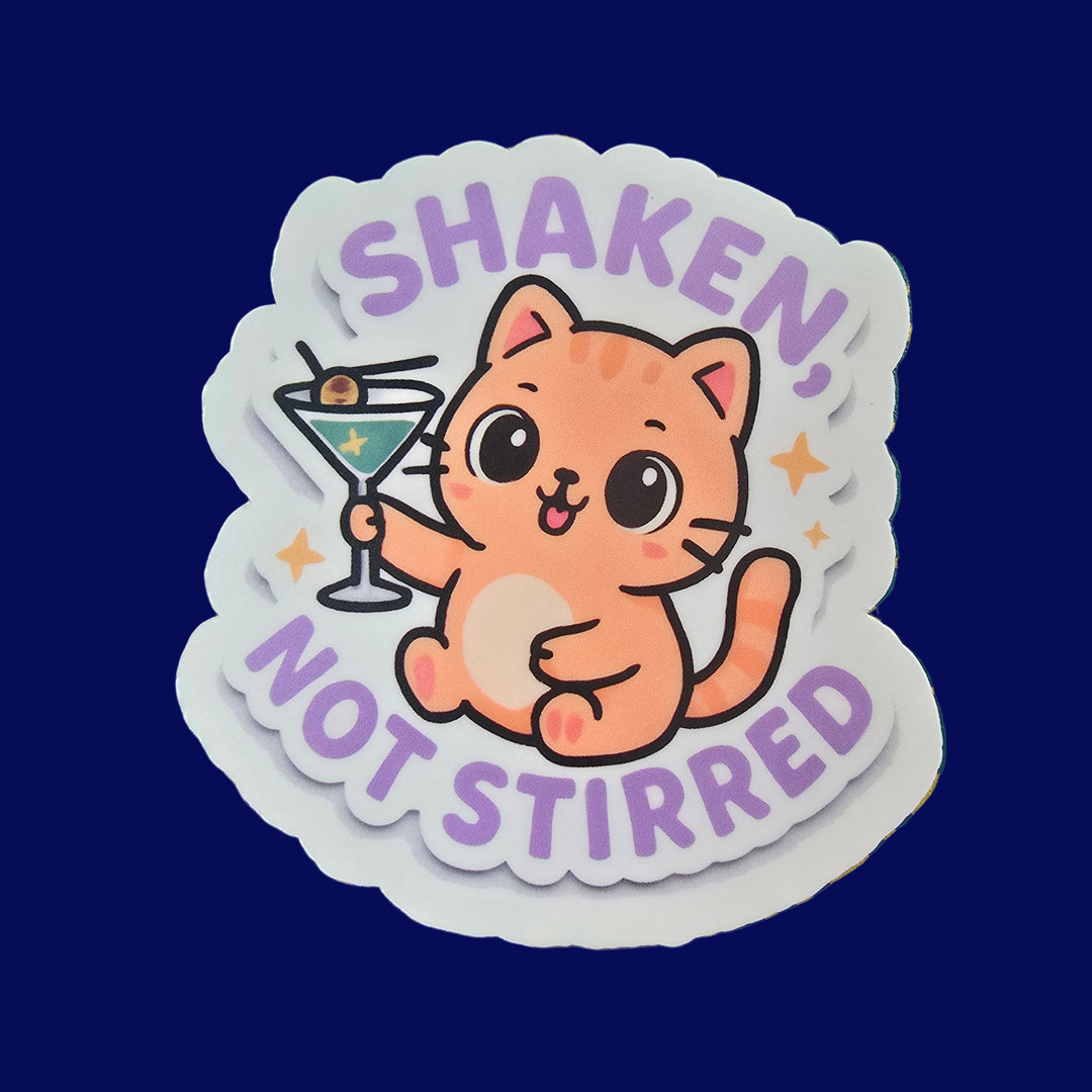 Cute orange cat holding martini with text “Shaken, Not Stirred” vinyl sticker