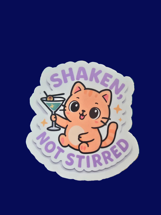 Cute orange cat holding martini with text “Shaken, Not Stirred” vinyl sticker