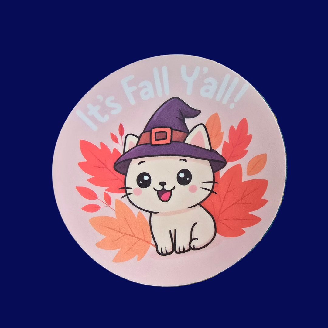 Cute white cat in witch hat with autumn leaves and text “It’s Fall Y’all” vinyl sticker