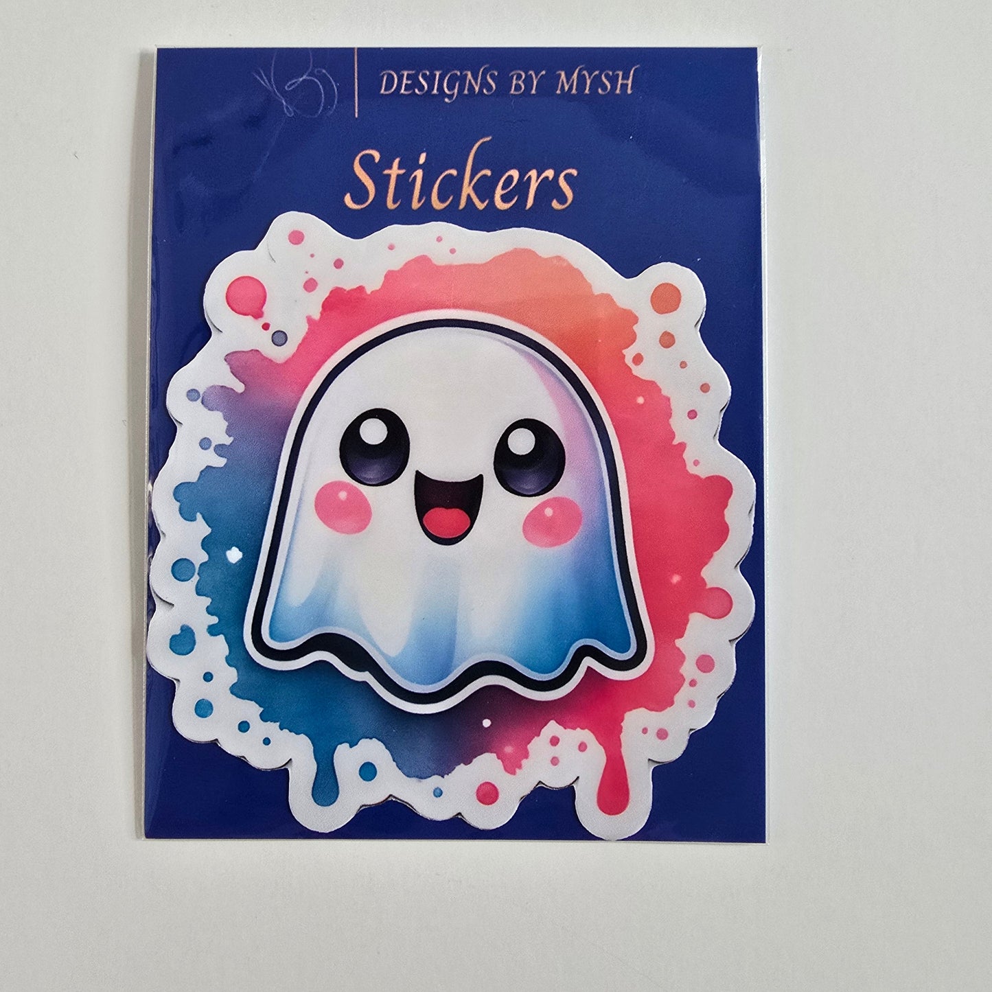 Cute rainbow ghost sticker with smiling face, blushing cheeks, and colorful pink and blue watercolor splash background.