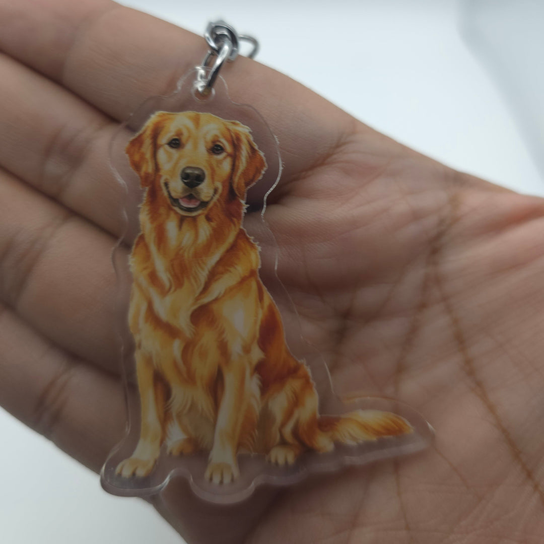Dog-shaped keychain held in a hand against a white background