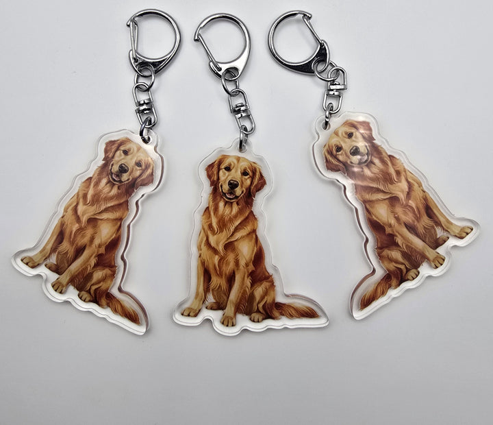 Three keychains with a dog design on a light gray background
