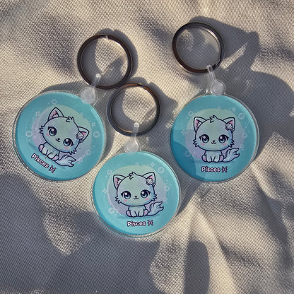 Three kawaii Pisces keychains arranged on fabric with shadows, astrology-themed accessories