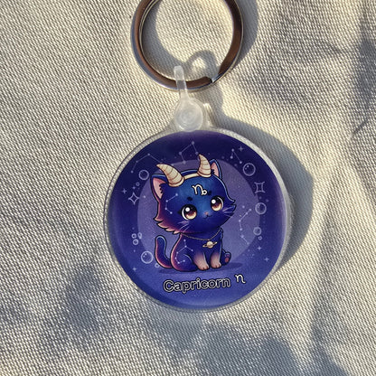 Keychain with a blue creature design on a light fabric background