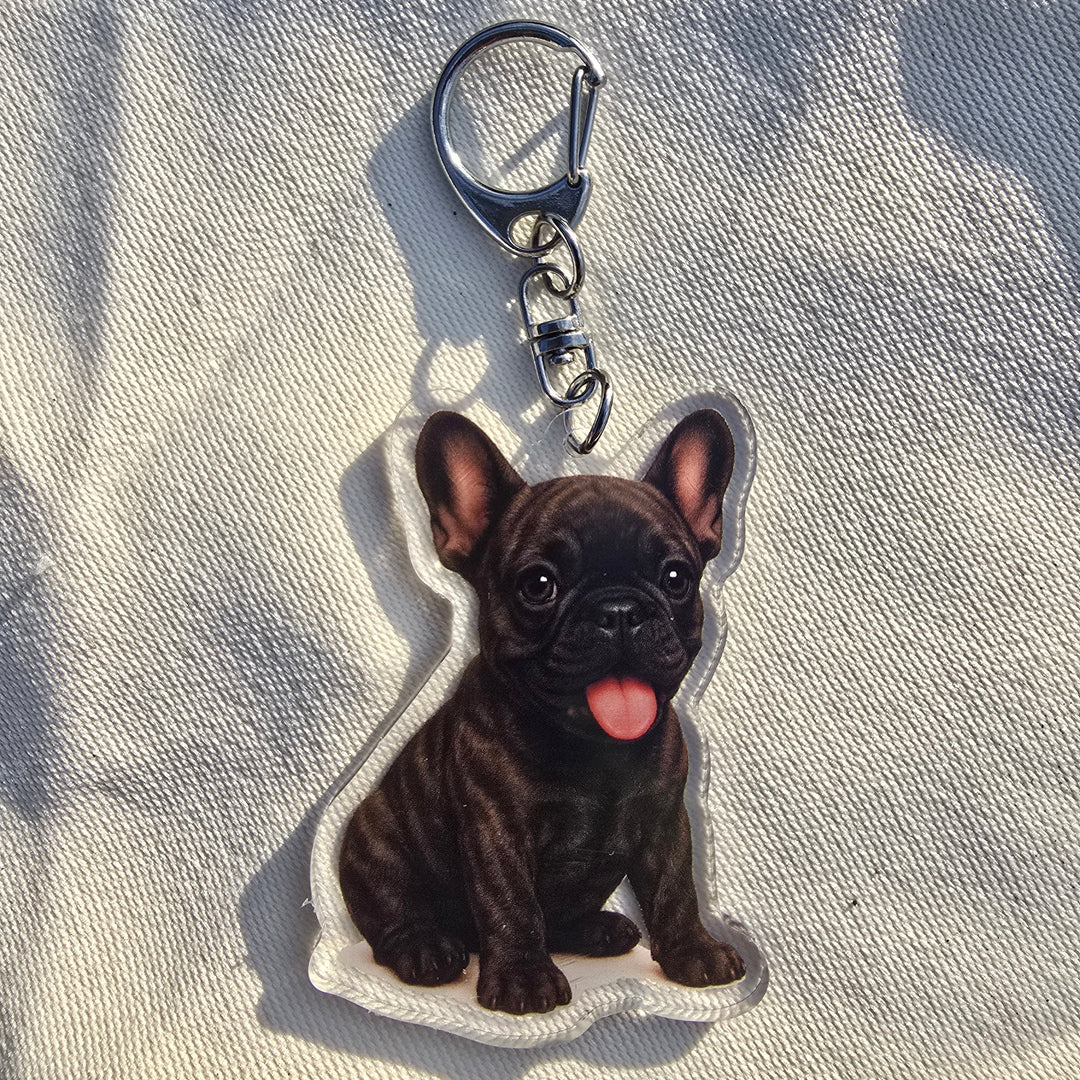 Keychain shaped like a dog on a textured fabric background