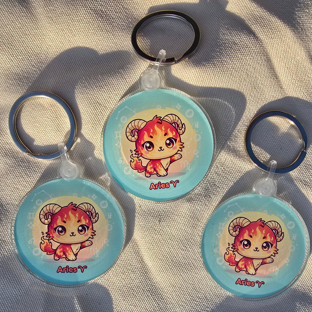 Three round keychains with a cartoon character on a textured surface