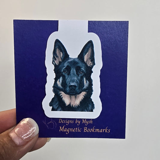 Hand holding a blue bookmark with a dog illustration and text on a white background