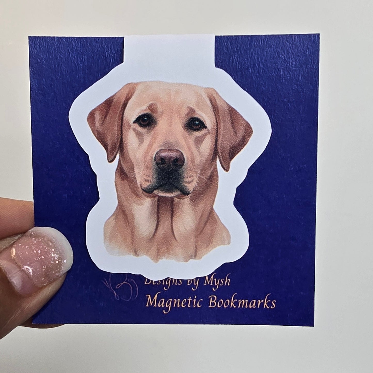 Dog-shaped magnetic bookmark on a blue card with text