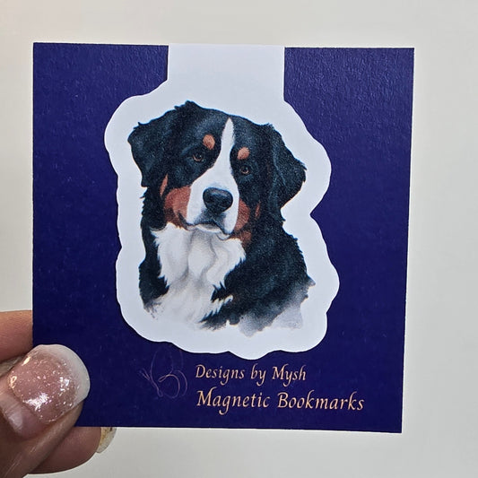 Magnetic bookmark with dog illustration on a blue card held against a tiled wall.