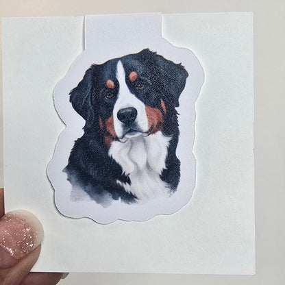 Sticker of a dog held by a hand on a white background