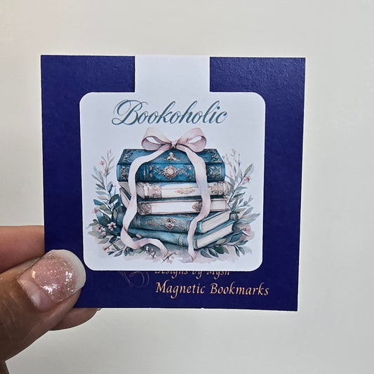 Card with decorative design and text held by a hand against a white background