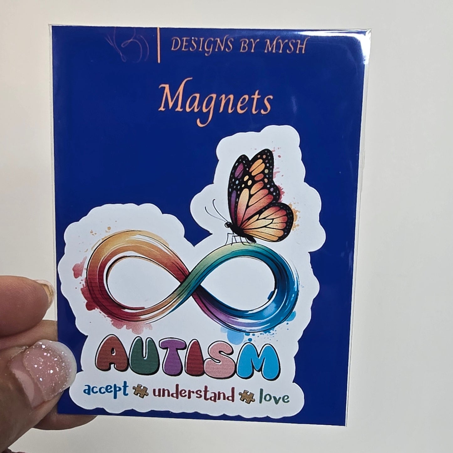 Autism awareness magnet packaging with a butterfly and number 8 design.