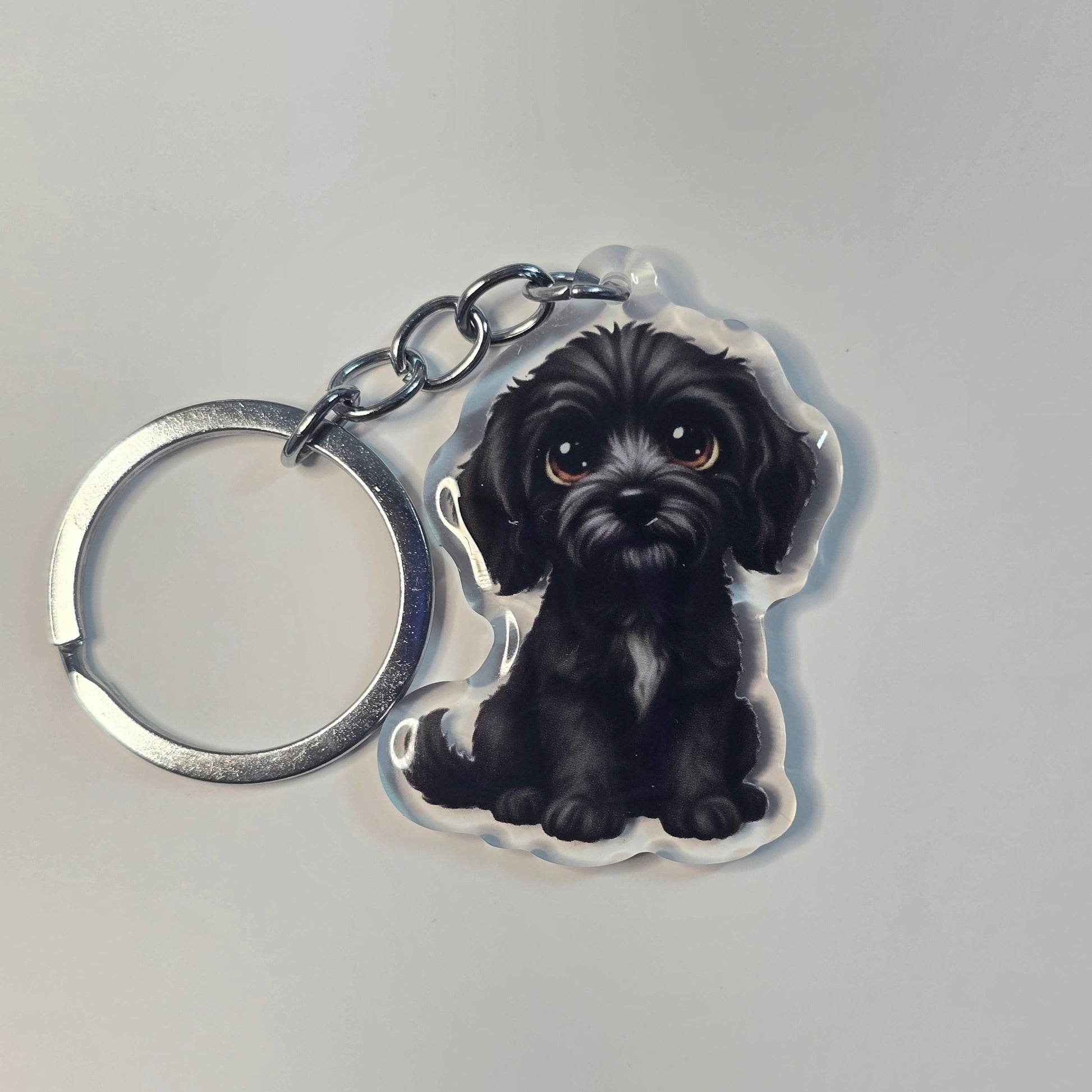 Keychain with a black dog design on a gray background