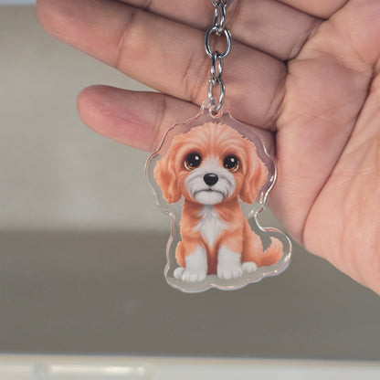 Hand holding a keychain with a dog design against a neutral background