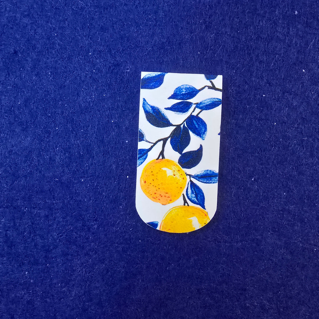 Small rectangular item with lemon and leaf design on a blue background