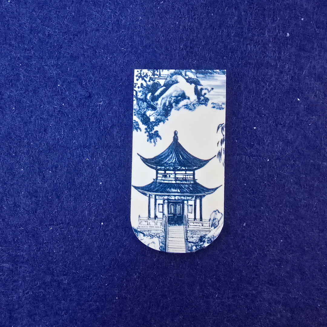 Blue and white ceramic tile with architectural design on a blue background