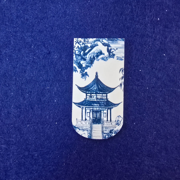 Blue and white ceramic tile with architectural design on a blue background