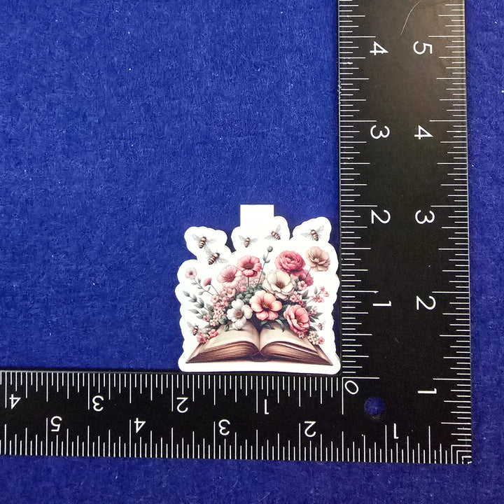 Decorative flower design on a blue background with a ruler for scale.