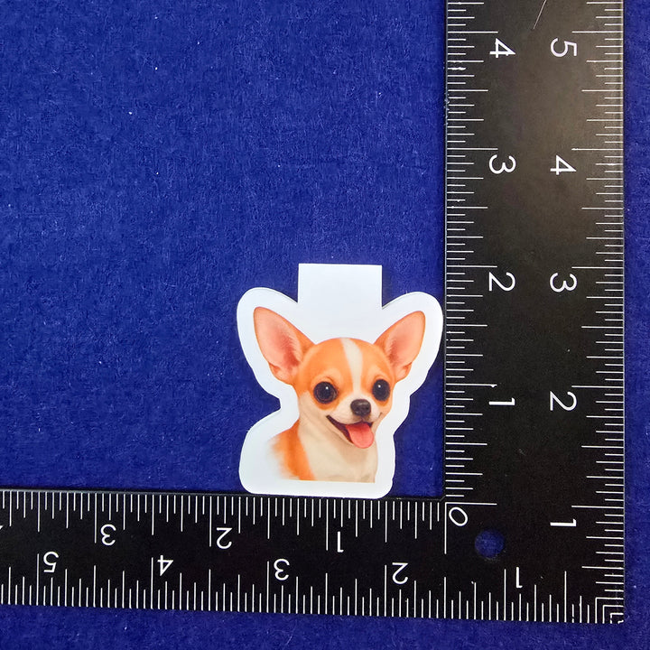 Sticker of a dog on a blue background with a ruler for scale.