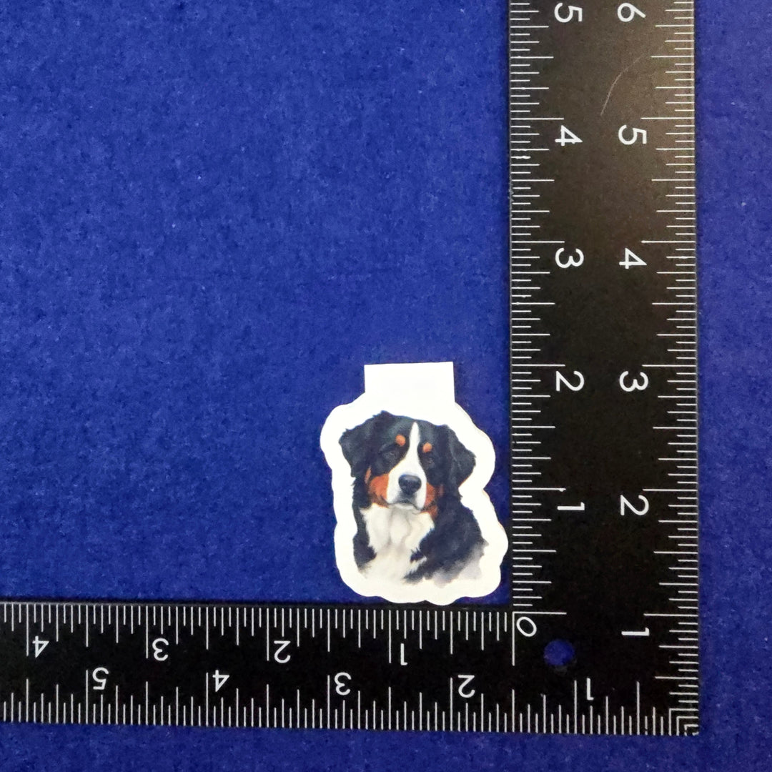 Sticker of a dog on a blue background with a ruler for scale.