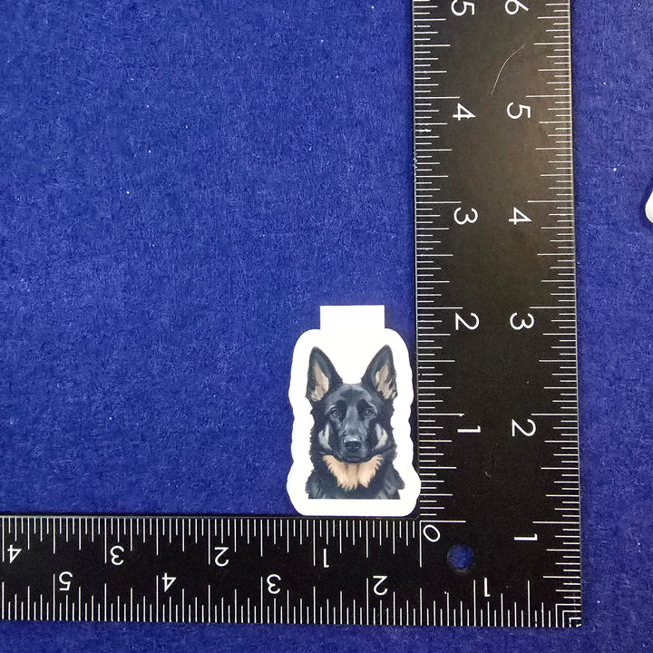Sticker of a dog on a blue background with a ruler for scale.