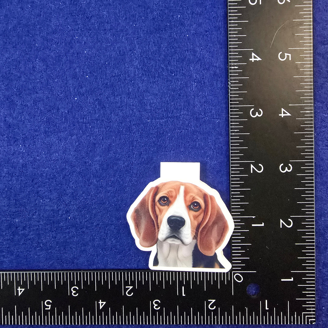 Dog-shaped hair clip on a blue background with a ruler for scale