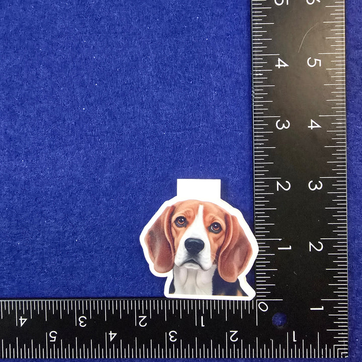 Dog-shaped hair clip on a blue background with a ruler for scale