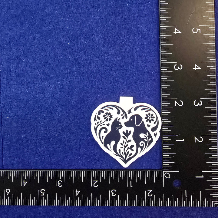 Decorative heart-shaped object on a blue background with a ruler for scale.
