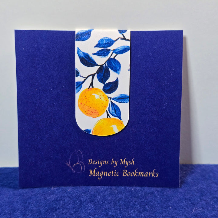 Blue magnetic bookmark with a decorative orange design on a white background
