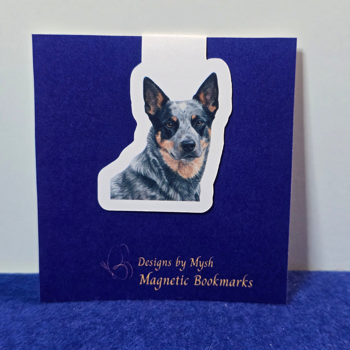 Blue book with a dog-shaped magnetic bookmark on a white background