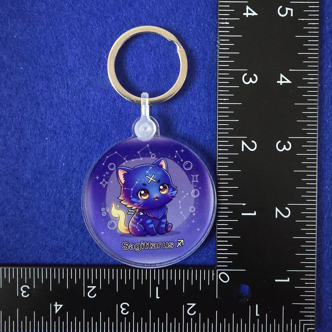 Keychain with a cartoon character on a blue background with a ruler for scale.