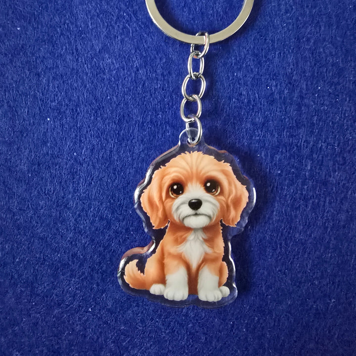 Keychain with a cartoon lion design on a blue background