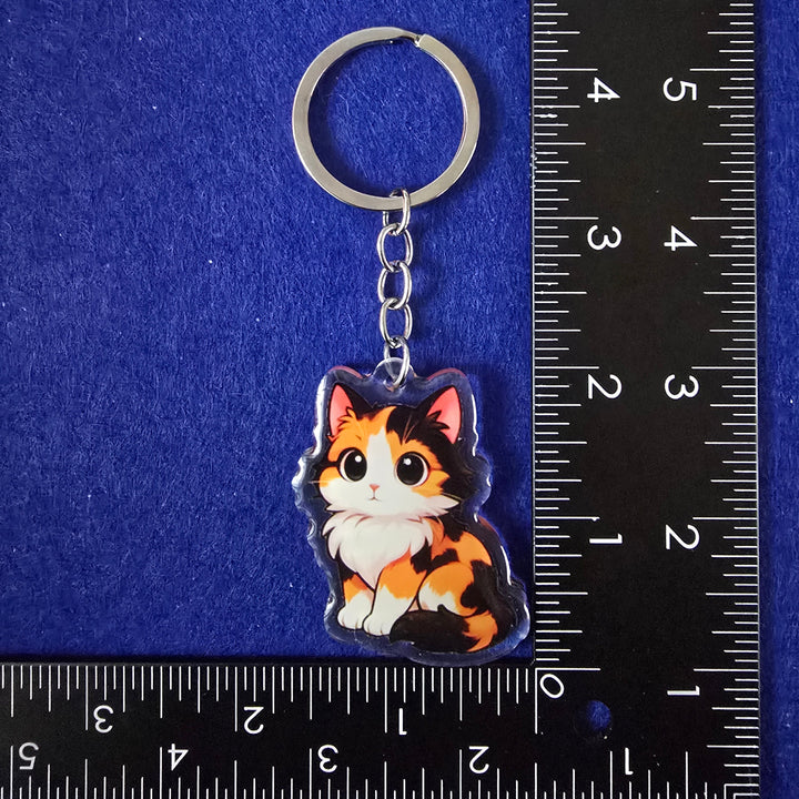 Keychain with a dog design on a blue background with a ruler for scale.