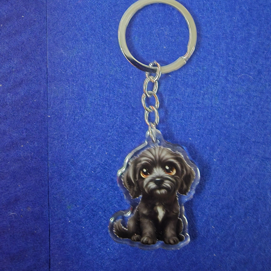 Keychain with a dog-shaped charm on a blue background