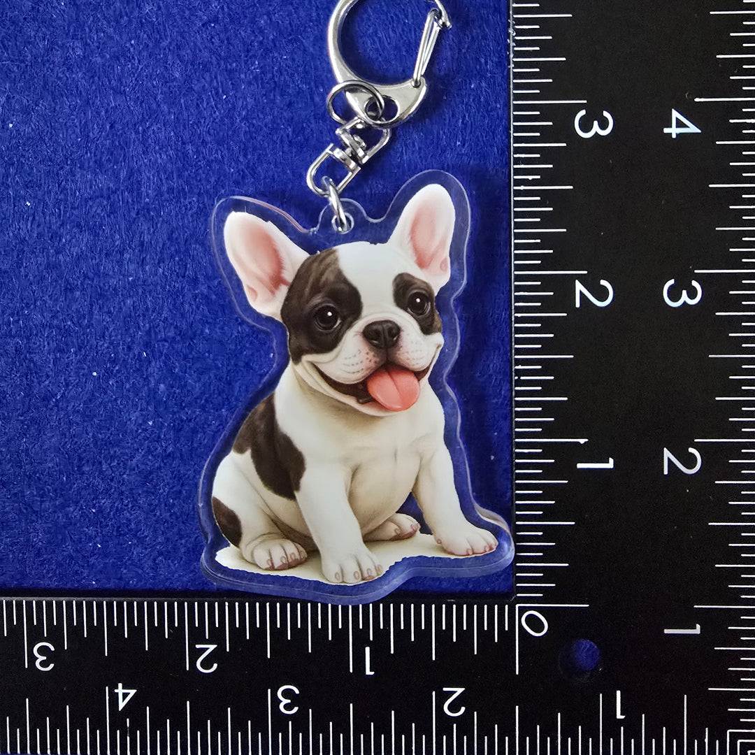 Keychain with a dog design on a blue background with a ruler for scale.