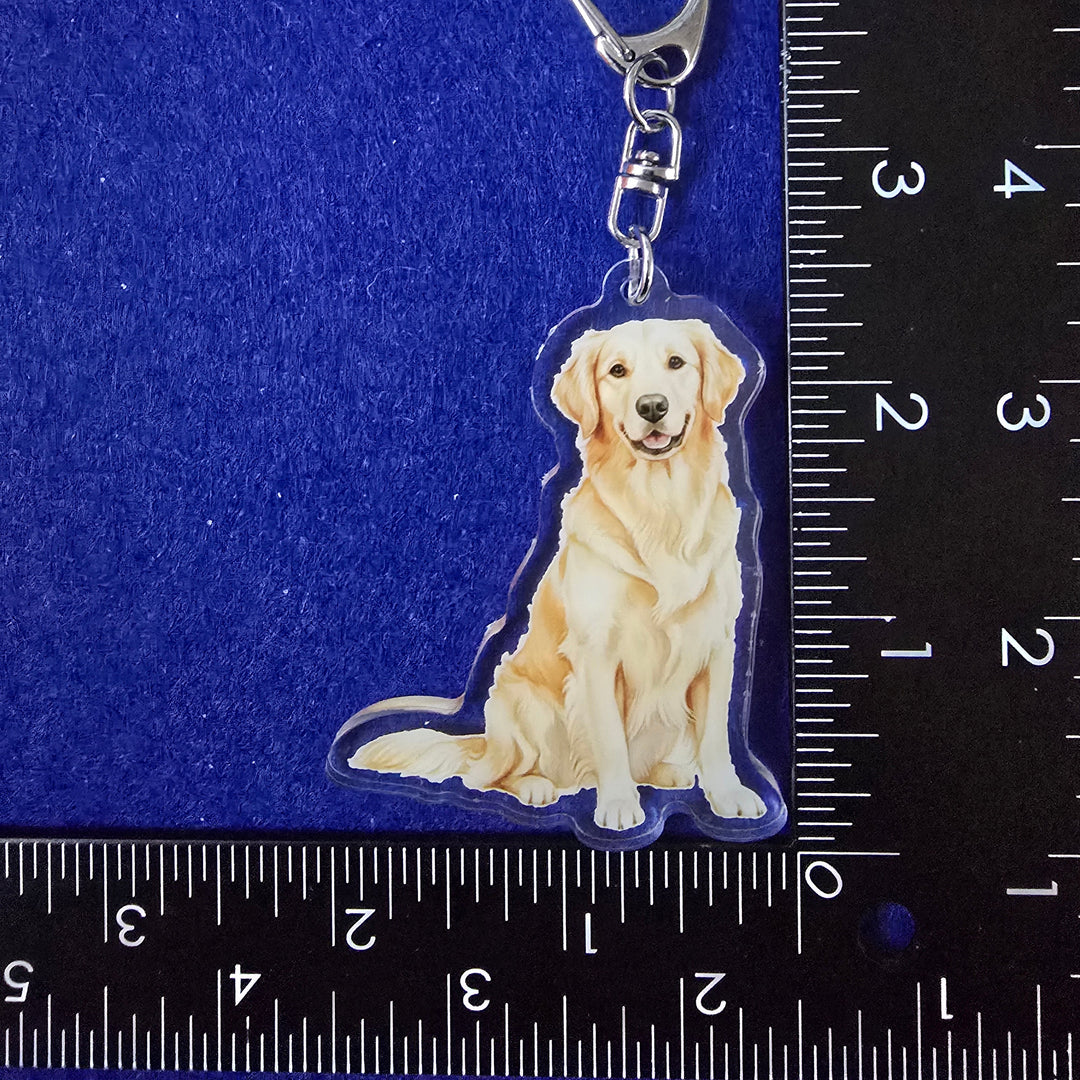 Dog-shaped keychain on a blue background with a ruler for scale